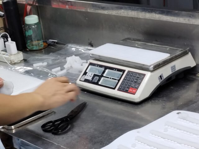 Weighting silicone material before molding